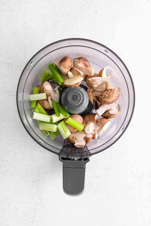 Mushrooms and green onion in a food processor. 