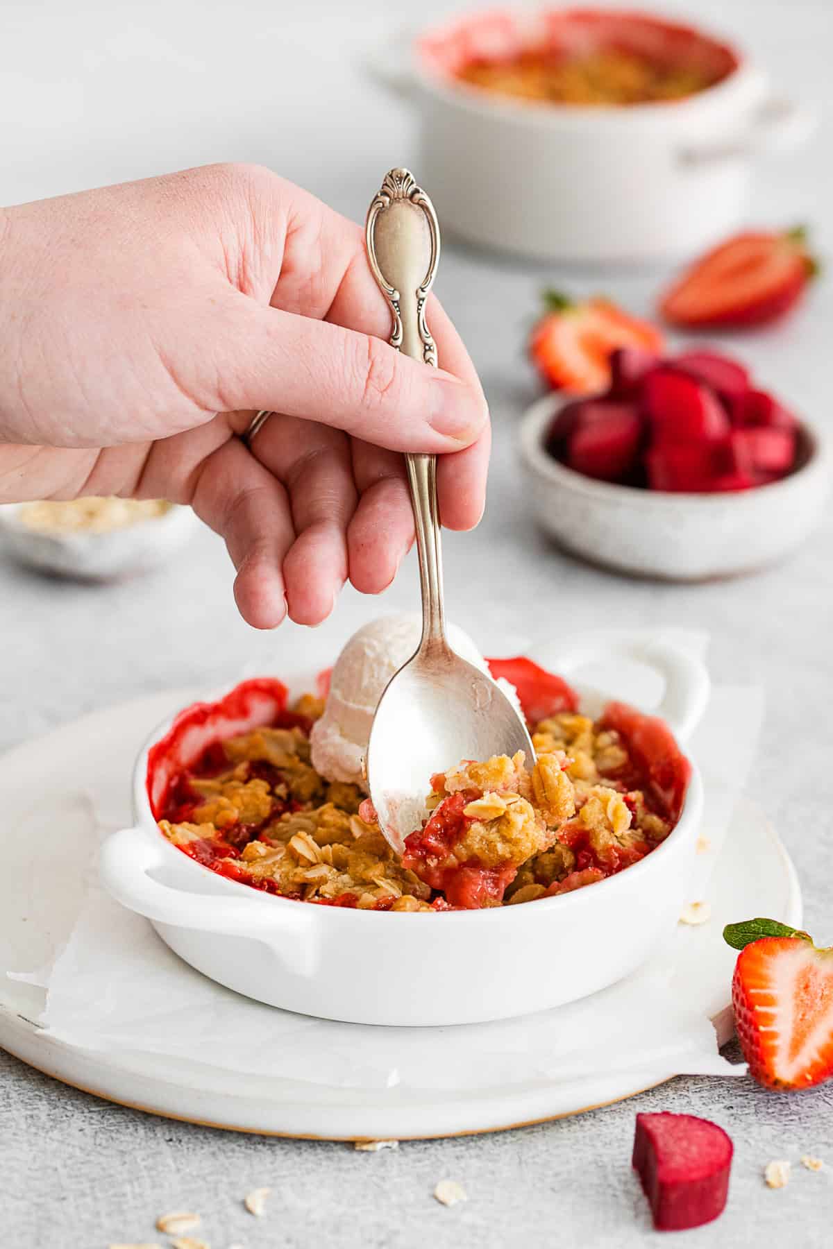 Strawberry Rhubarb Crisp in a dish with a spoon.