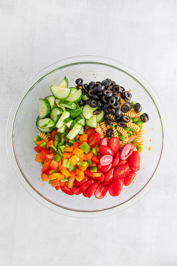 Pasta salad ingredients in a bowl. 