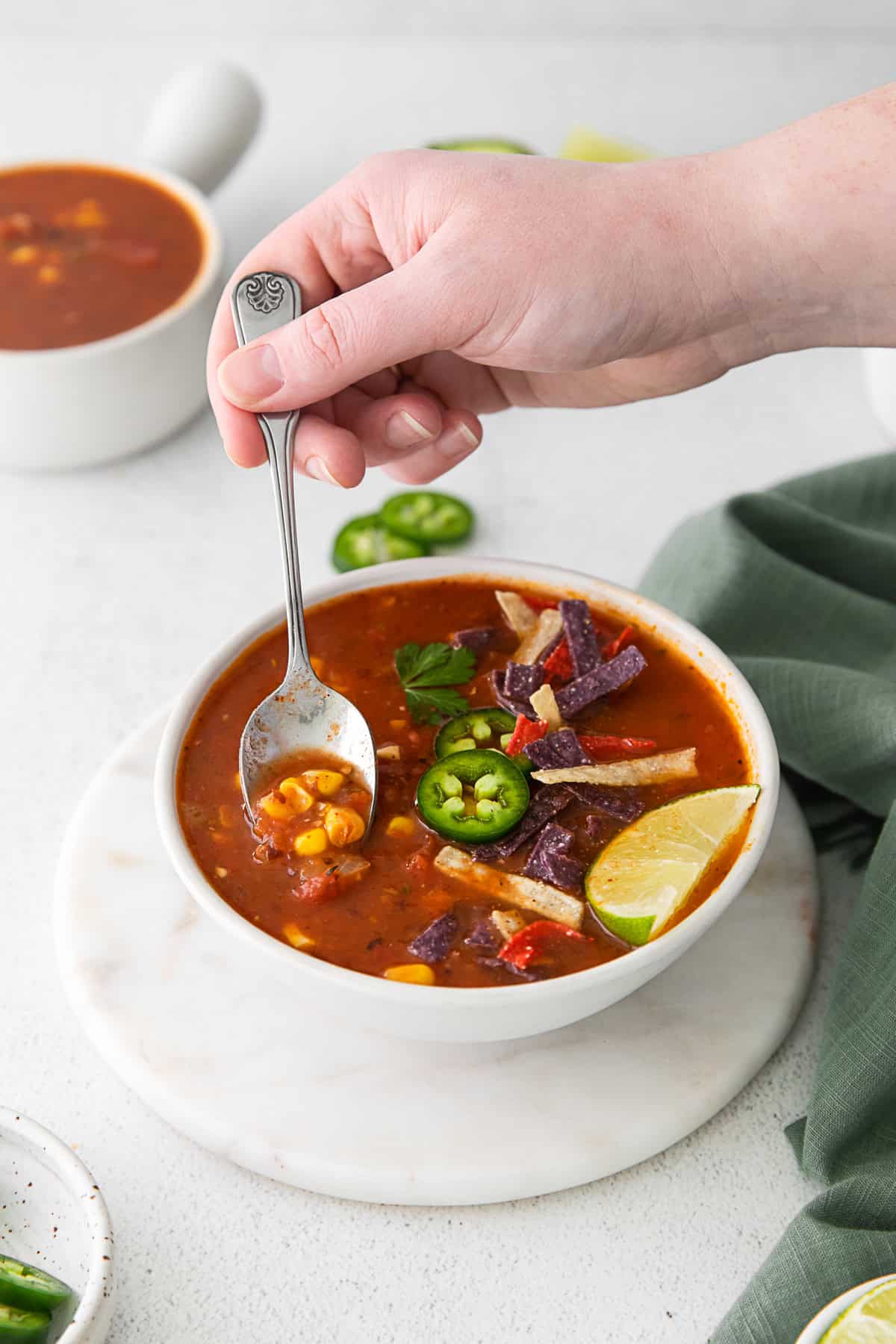 A spoon getting a bite of Vegan Tortilla Soup. 