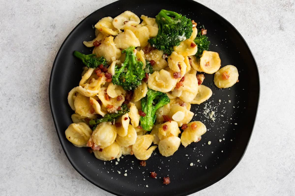 Broccoli Rabe Pancetta Pasta on a black plate.