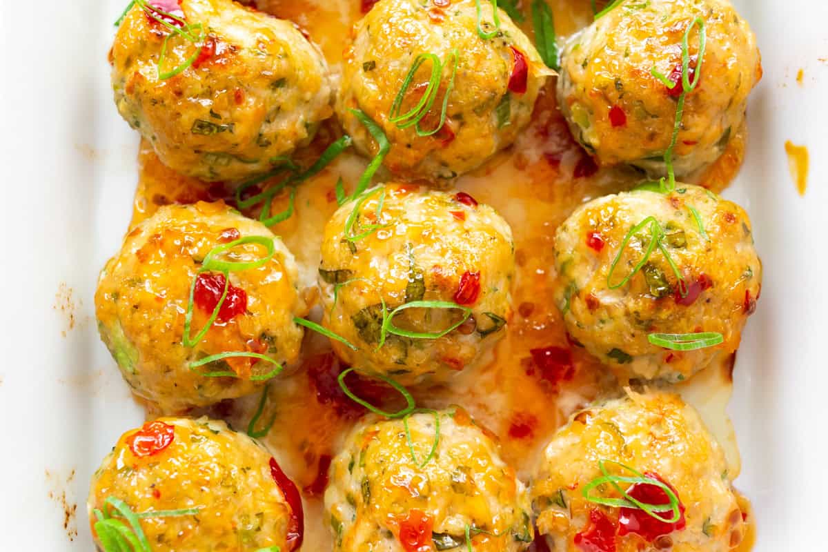 Easy Thai Baked Chicken Meatballs glazed with sweet chili sauce.