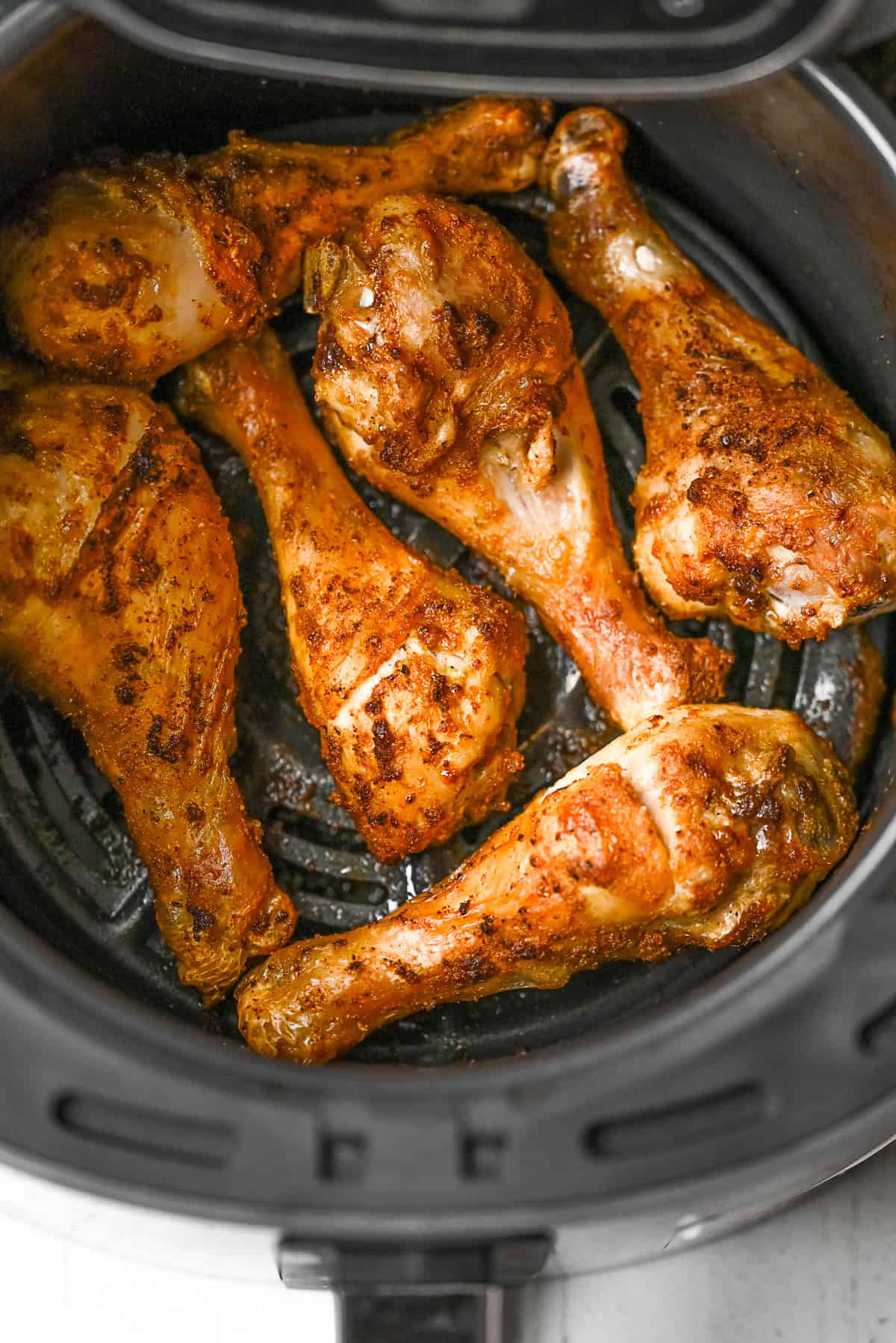 Air Fryer Chicken Legs in the air fryer basket. 