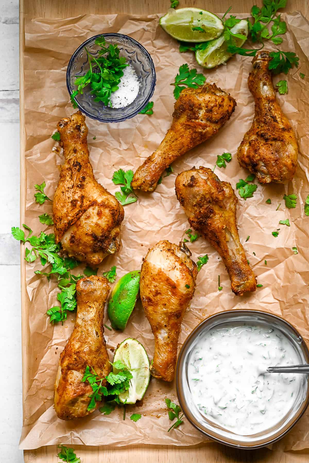 Air Fryer Chicken Legs sitting on parchment paper. 