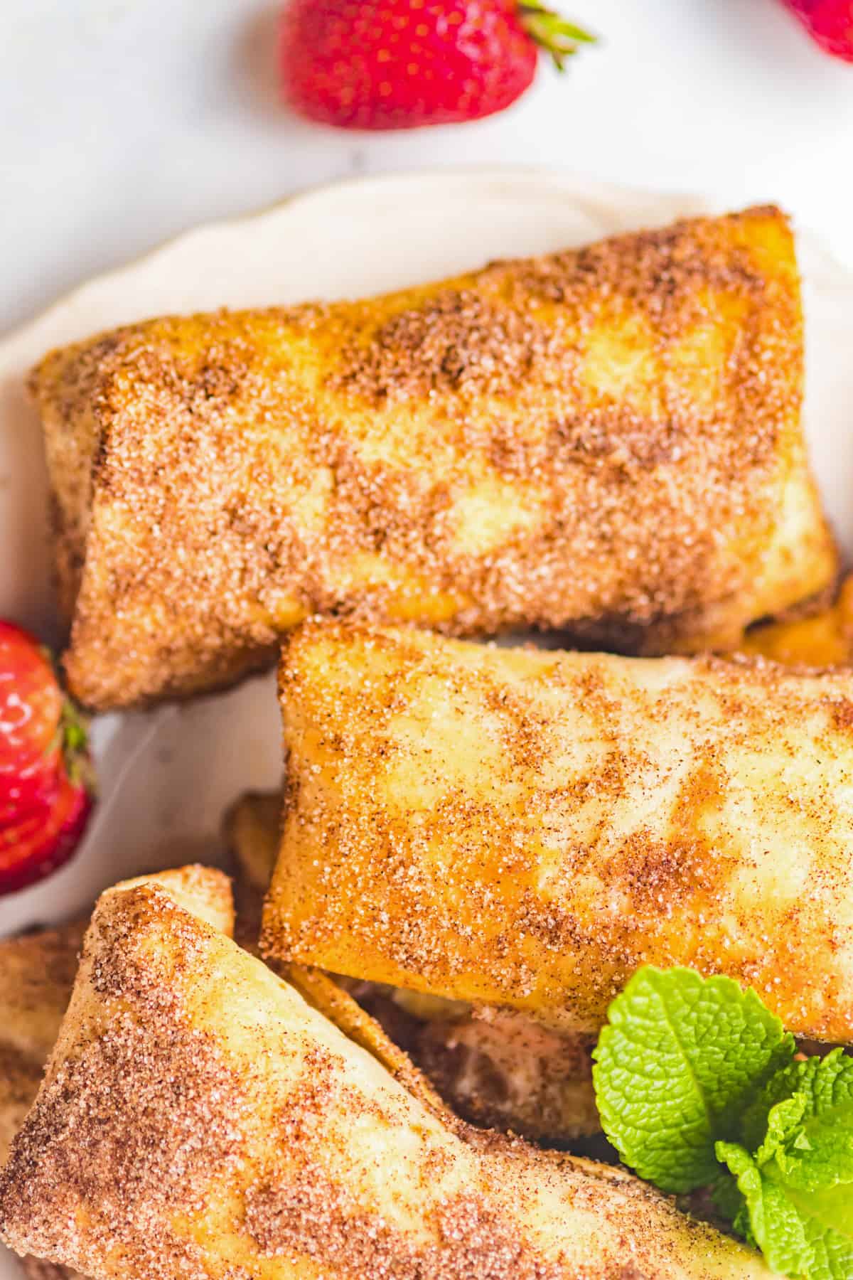 Strawberry Cheesecake Chimichangas tossed in cinnamon sugar. 