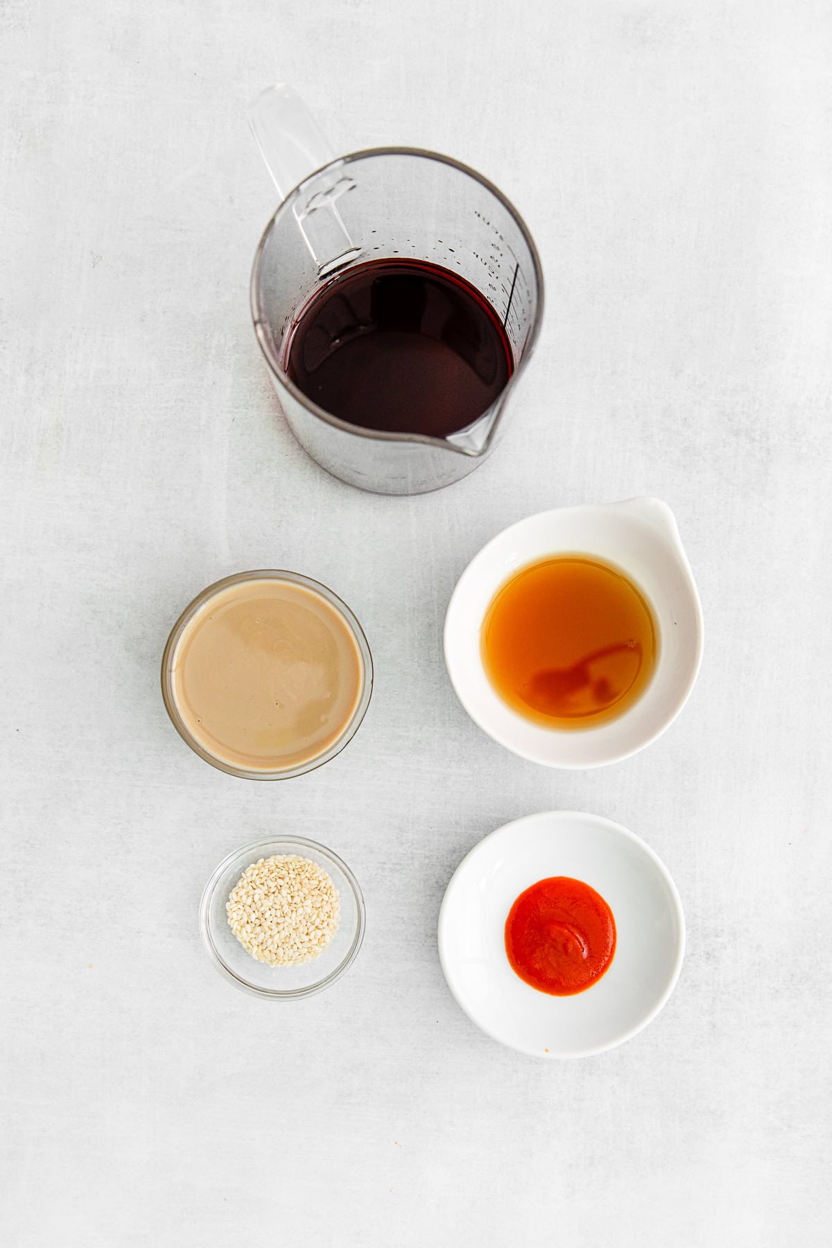 Ingredients for spicy tahini soy sauce on a table. 