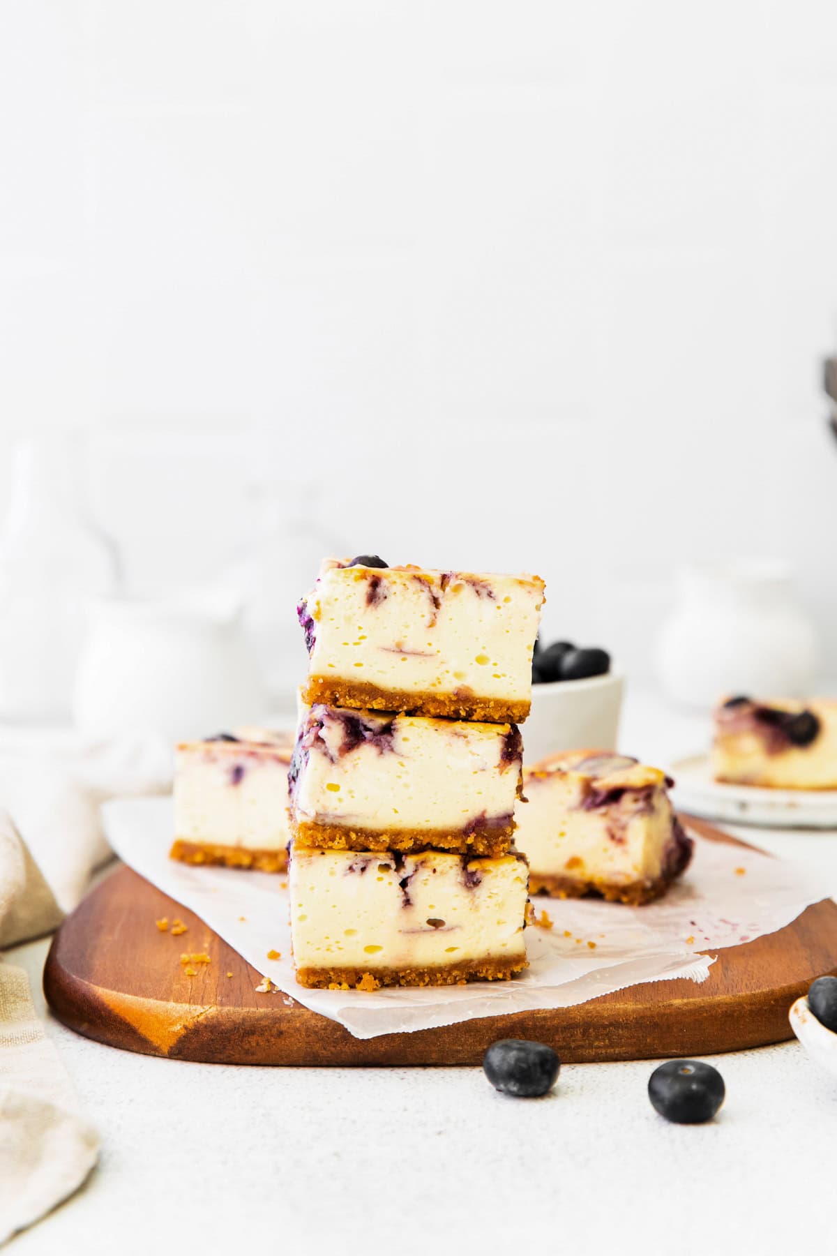 Blueberry Cheesecake Bars stacked on top of each other. 