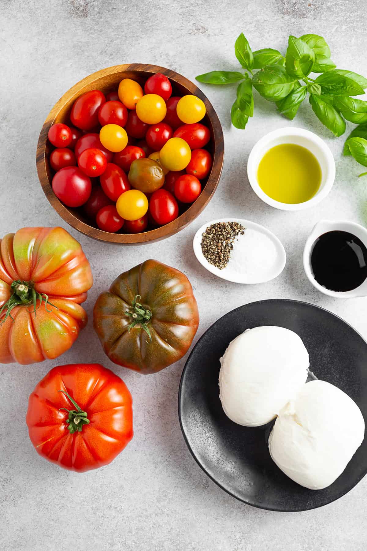 Burrata Caprese Salad ingredients on a table. 