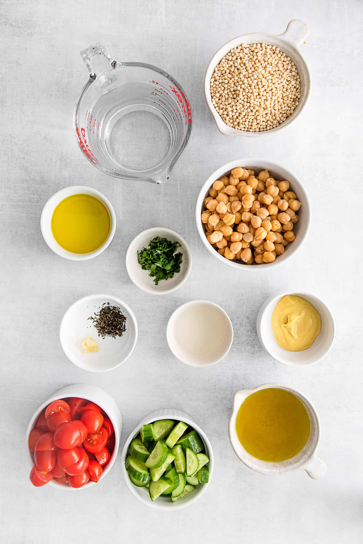 Mediterranean Couscous Salad ingredients on a table.