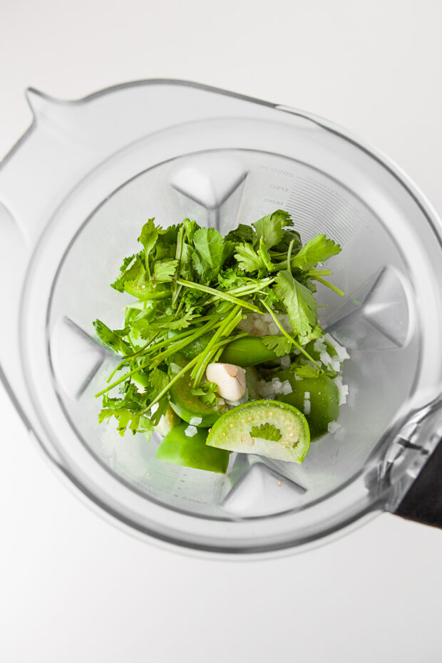 Cilantro, garlic, tomatillos, onion, and lime juice in a blender. 