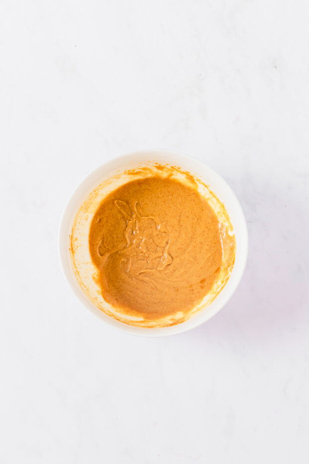 A bowl of peanut sauce. 