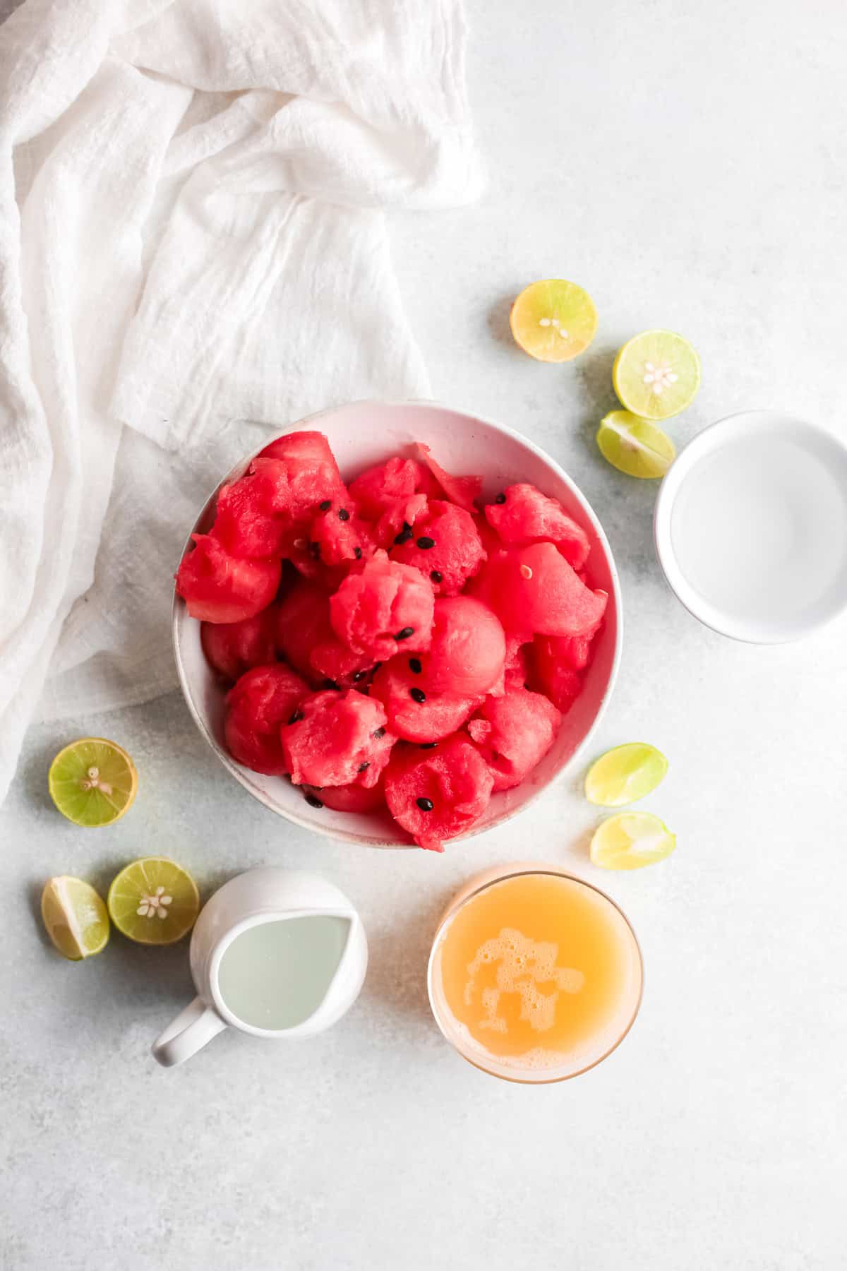 Ingredients to make a watermelon Paloma sitting on a table. 