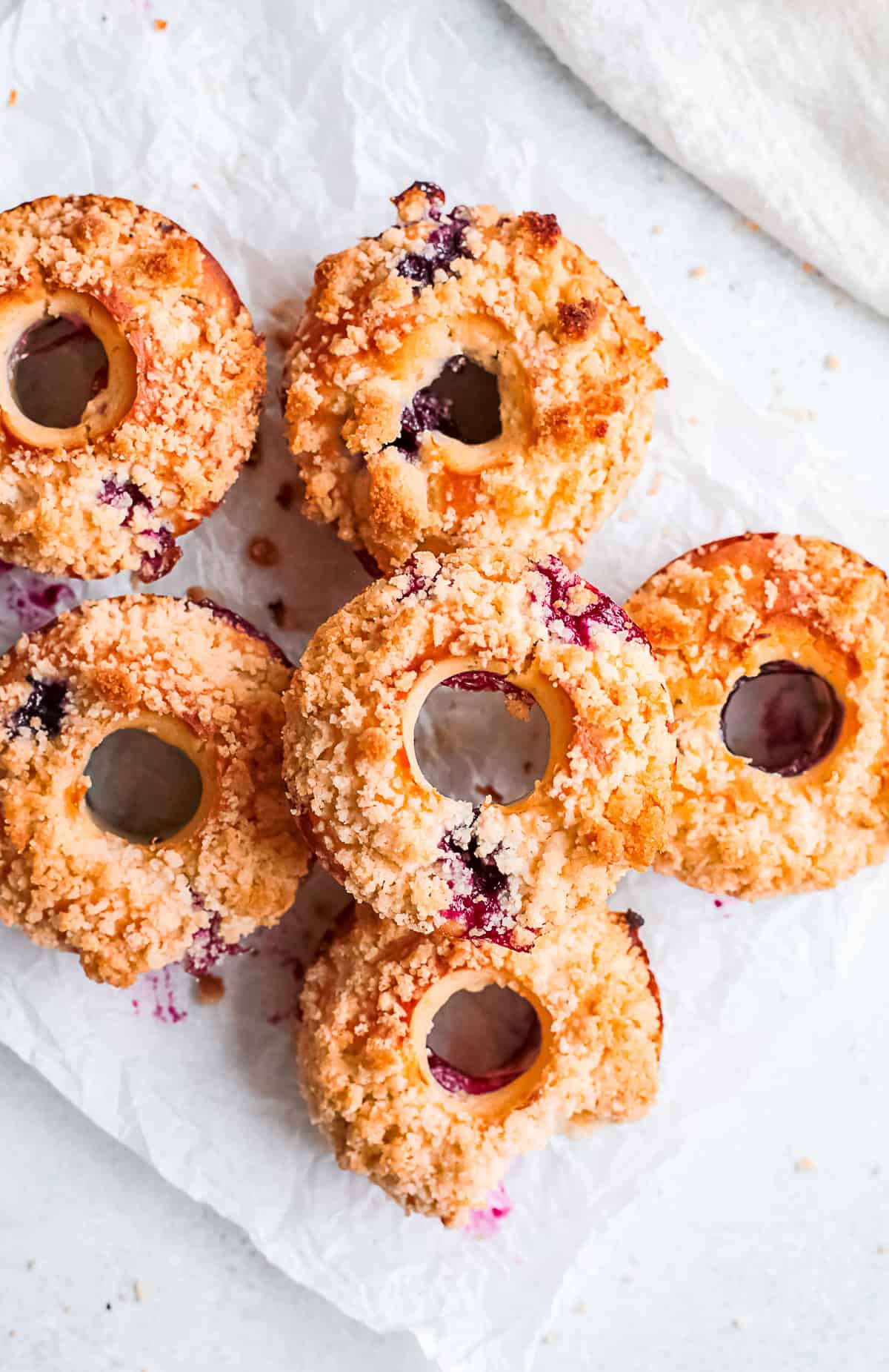 Baked Blueberry Streusel Donuts with a bite taken out of it.