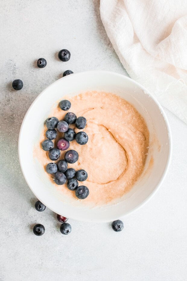 Donut batter with fresh blueberries mixed in.