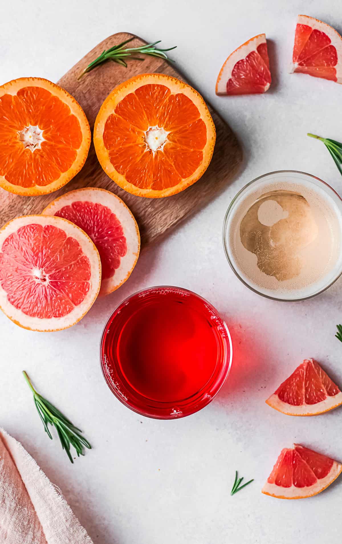 Aperol, champagne, and fresh fruit slices on a table. 