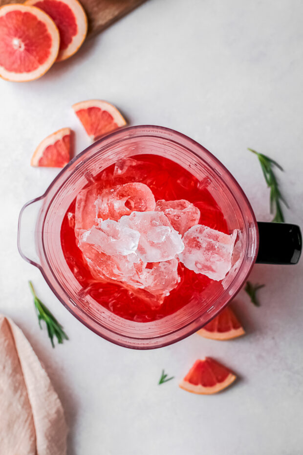 A blender filled with alcohol and ice. 