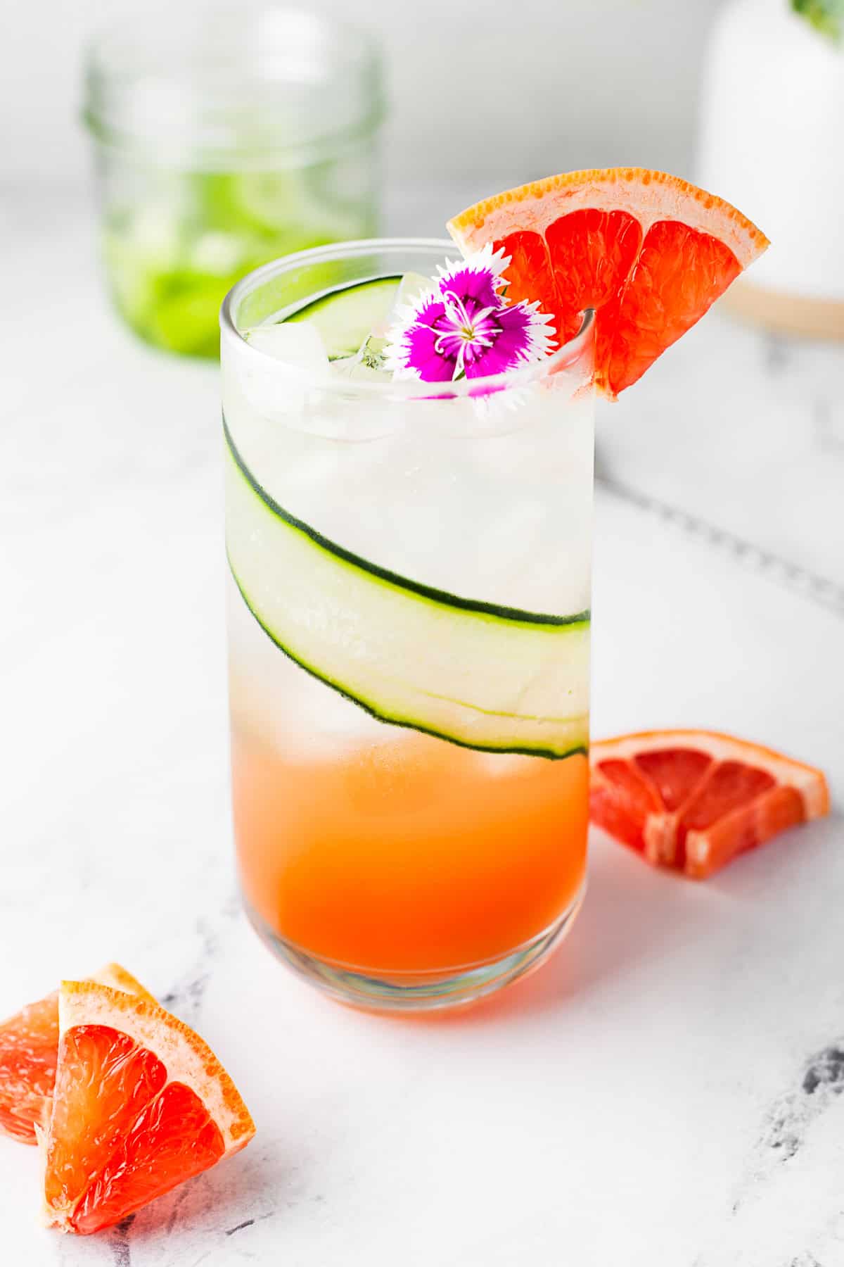 Grapefruit Gin Fizz garnished with an edible flour. 