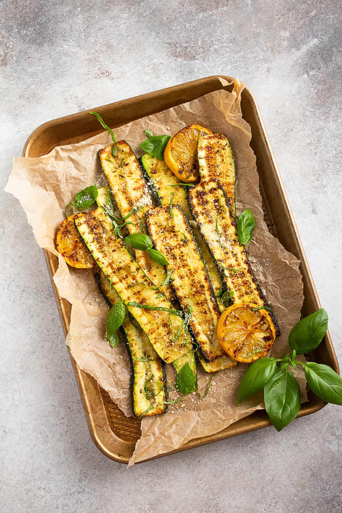 Grilled Zucchini on a sheet with grilled lemon. 