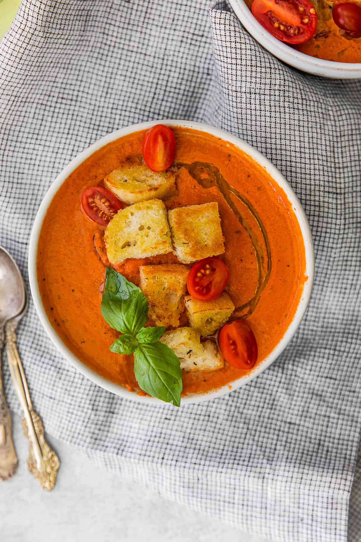 Instant Pot Tomato Soup topped with croutons and cherry tomatoes.