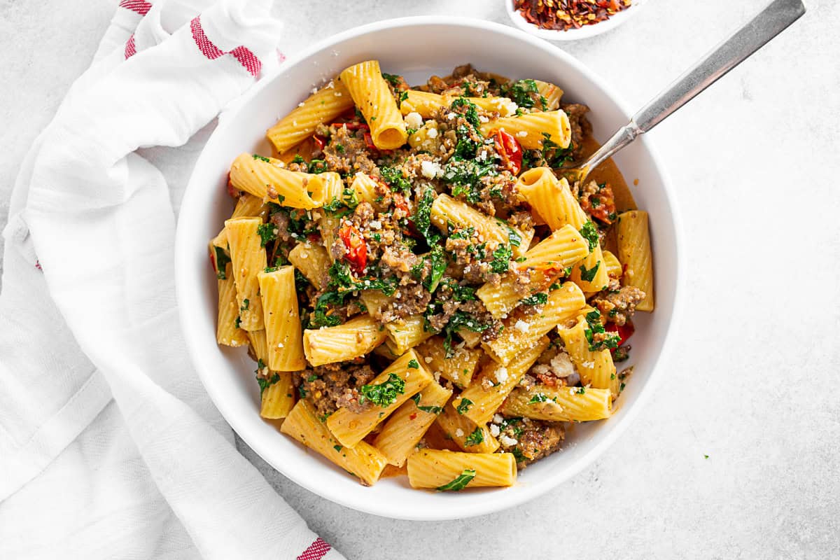 Italian Sausage Kale Pasta served with a napkin and fork. 
