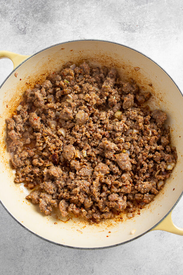 Browned Italian sausage in a skillet. 