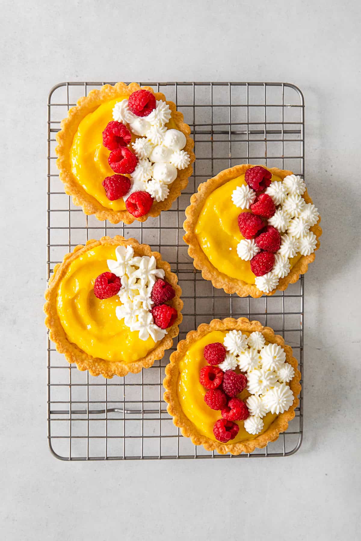 Lemon Curd Tarts cooling on a baking rack. 