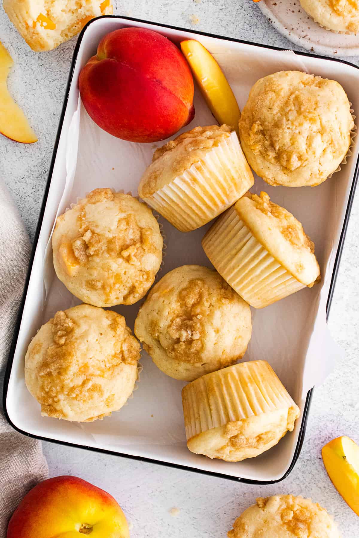 Peach Streusel Muffins in a metal tin. 