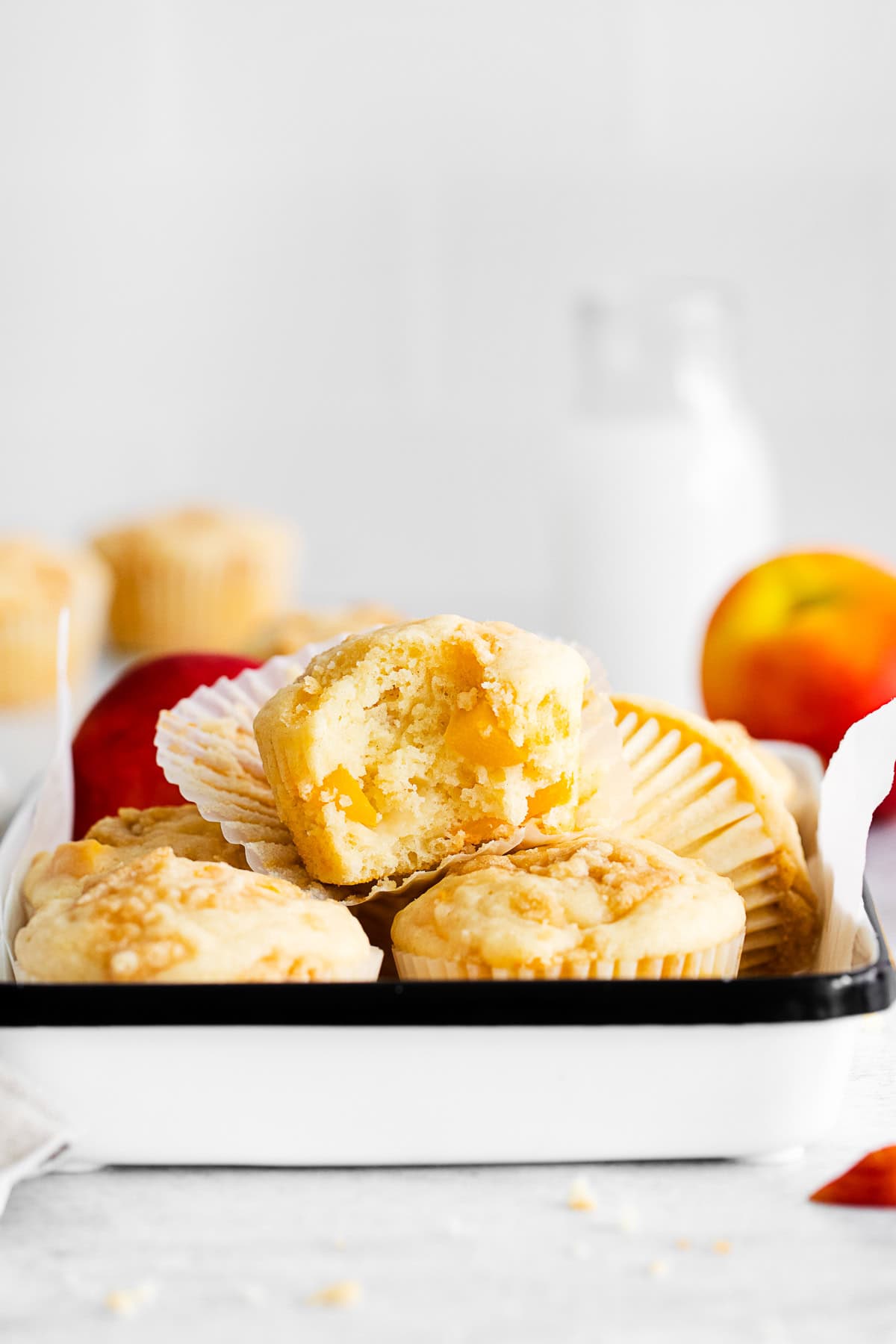 Peach Streusel Muffins with a bite taken out of it. 