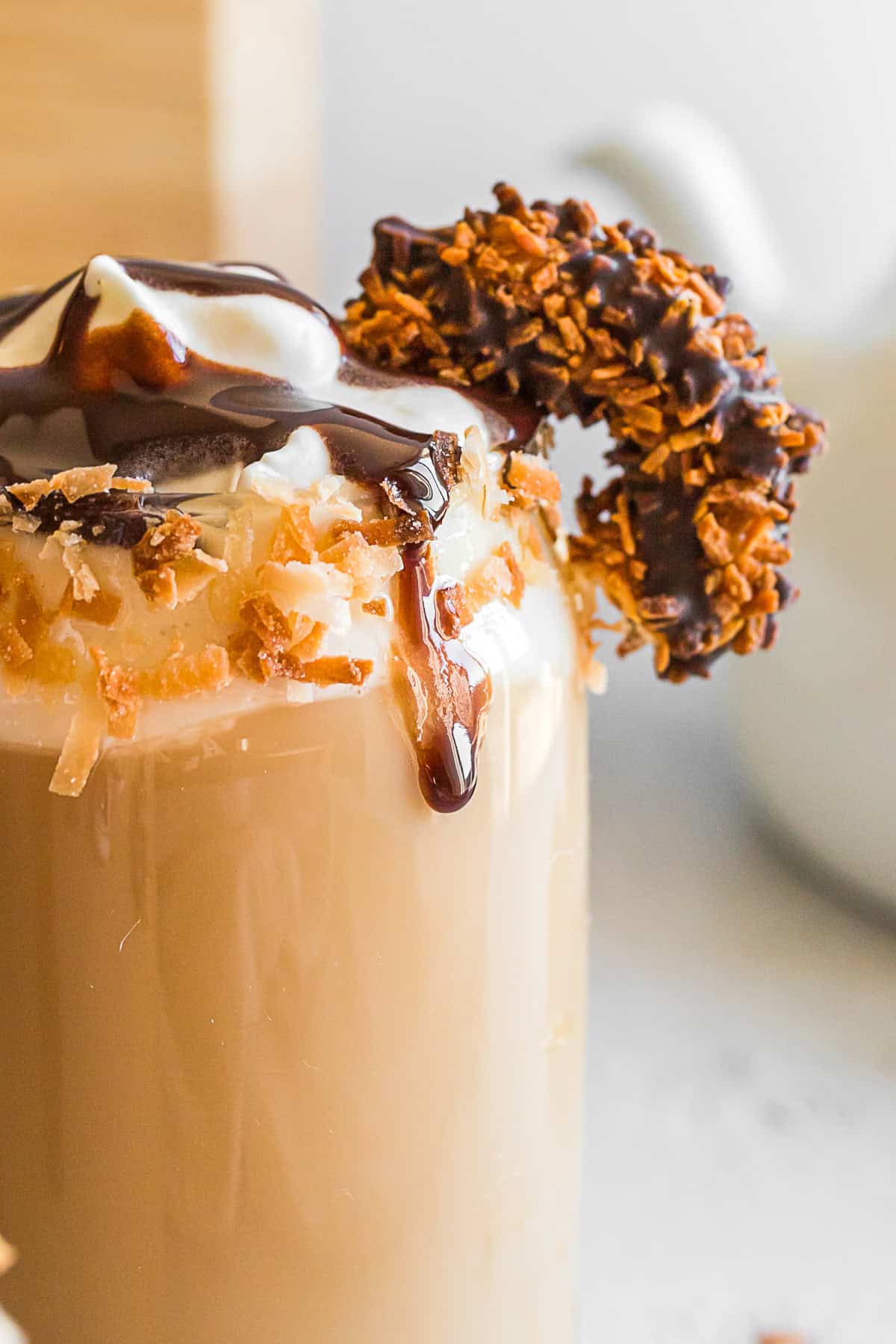 Samoas Iced Coffee garnished with a cookie.