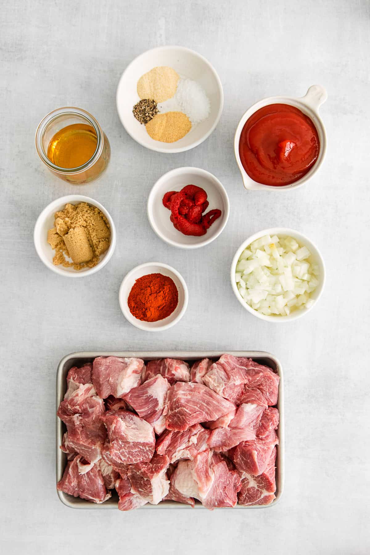 Ingredients to make slow cooker pulled pork on a table. 