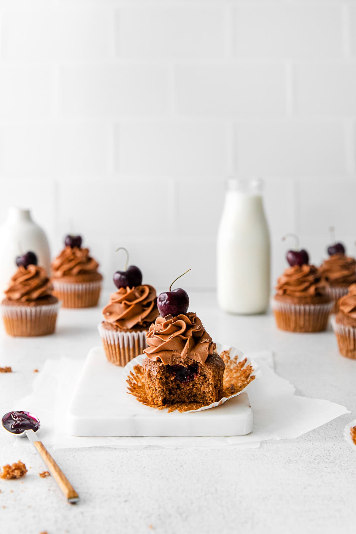 A Black Forest Cupcakes with a bite taken out of it. 