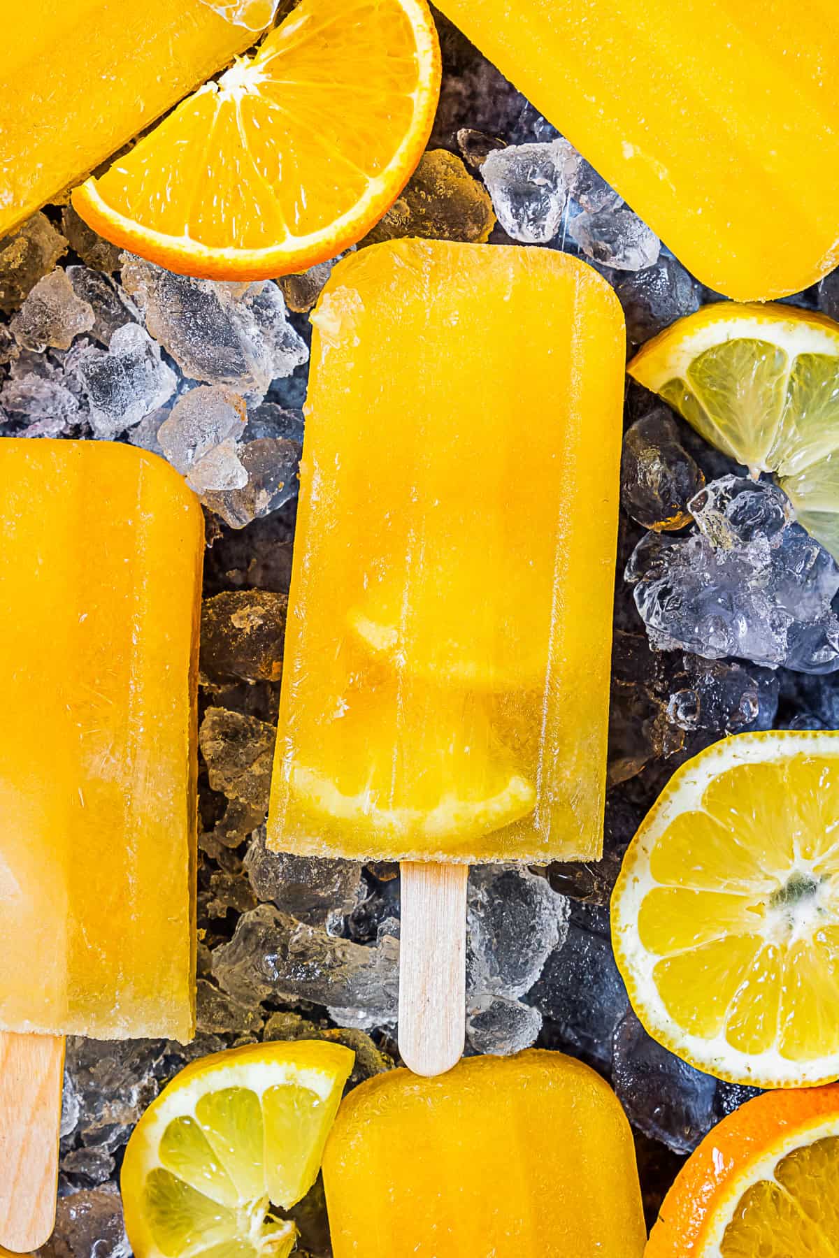 Citrus Popsicles with fruit slices in the ice pops.