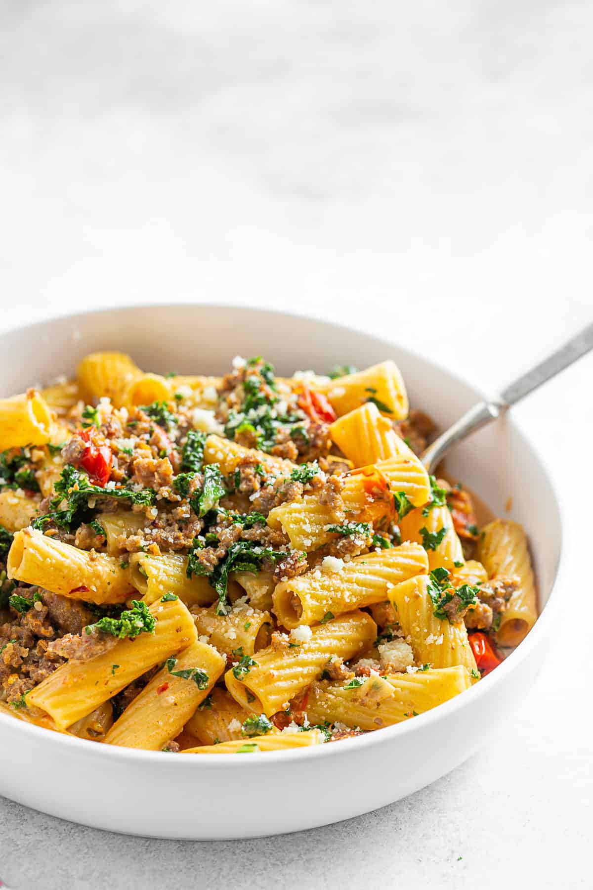 Italian Sausage Kale Pasta in a bowl with a fork.