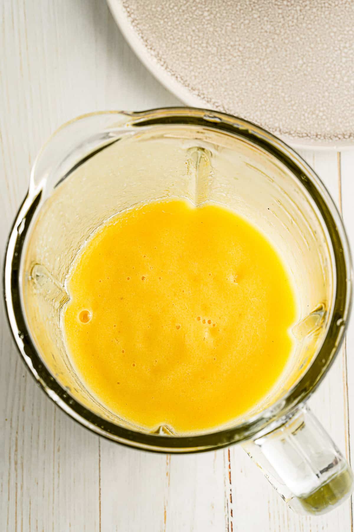 Mango Pineapple Smoothie in a blender vessel. 