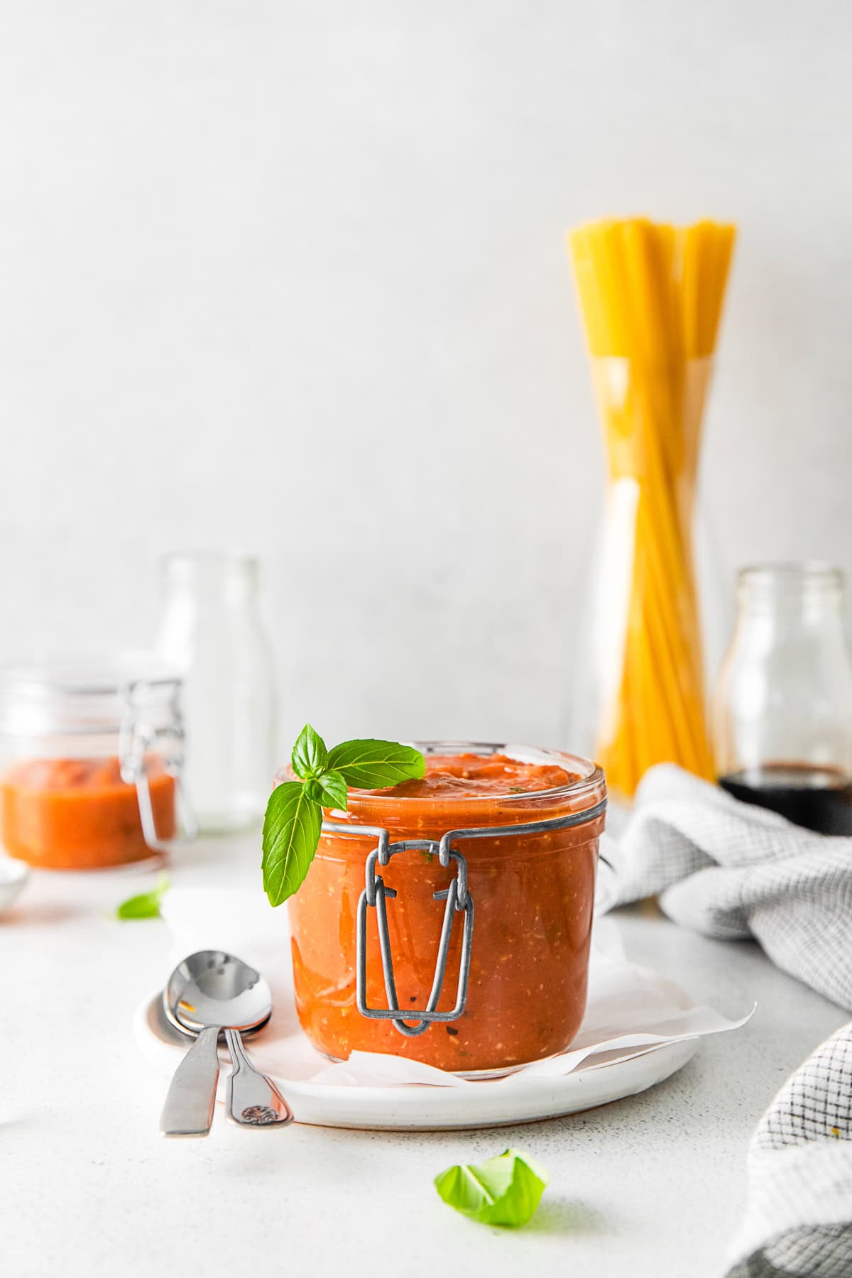 Roasted Tomato Sauce in a jar with fresh basil. 