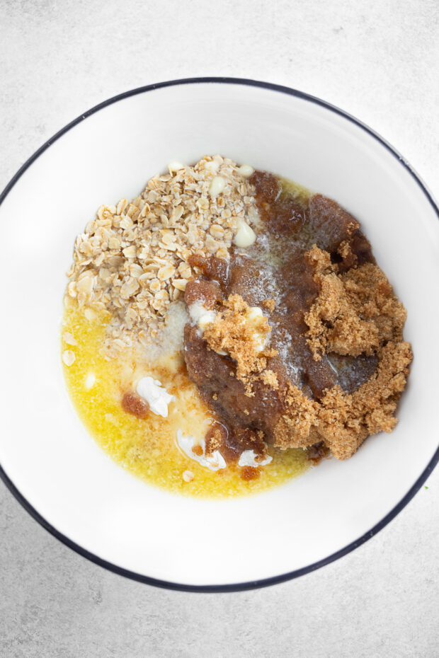 Brown sugar, butter, and oats in a bowl. 