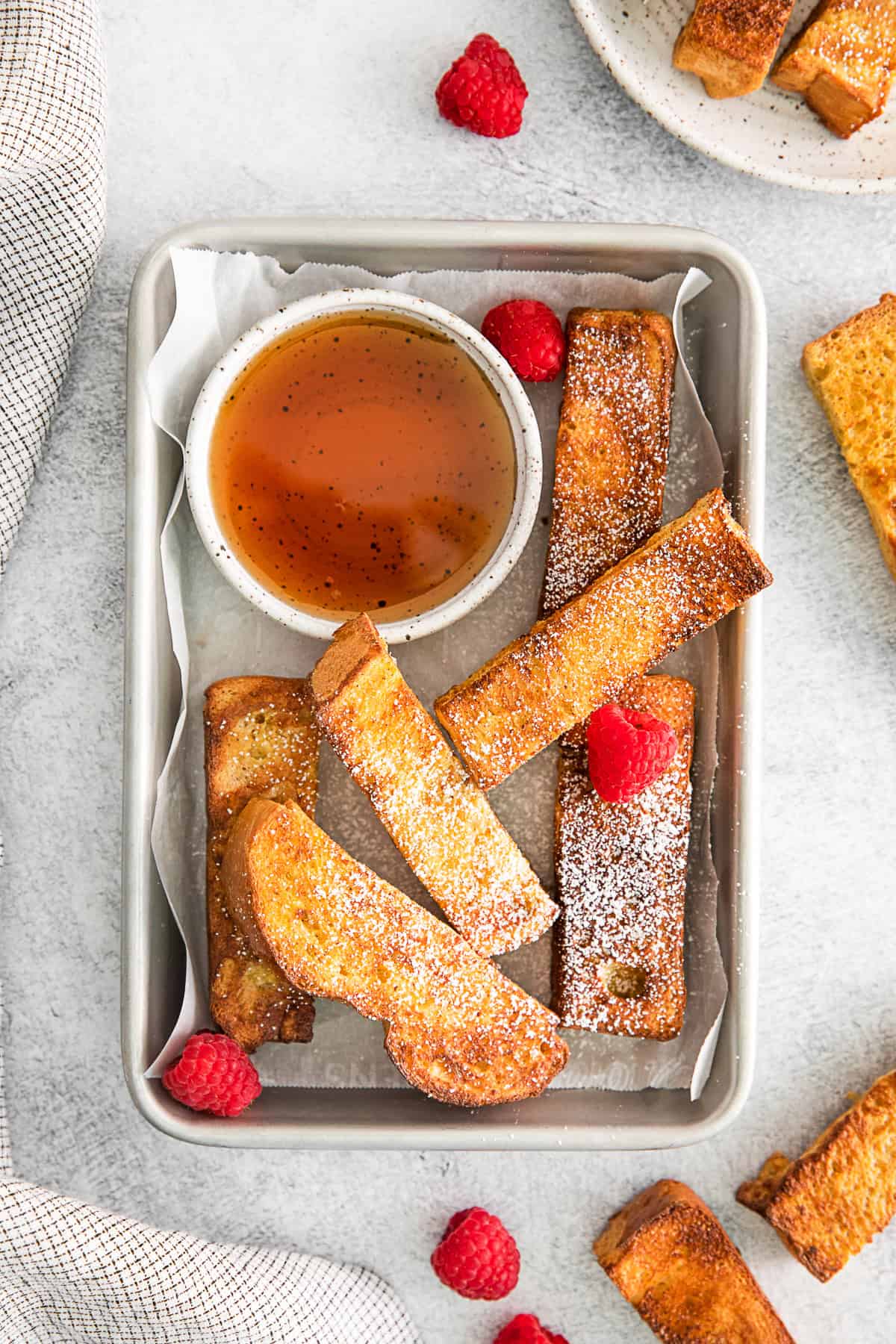 Air Fryer French Toast Sticks on a metal tray.