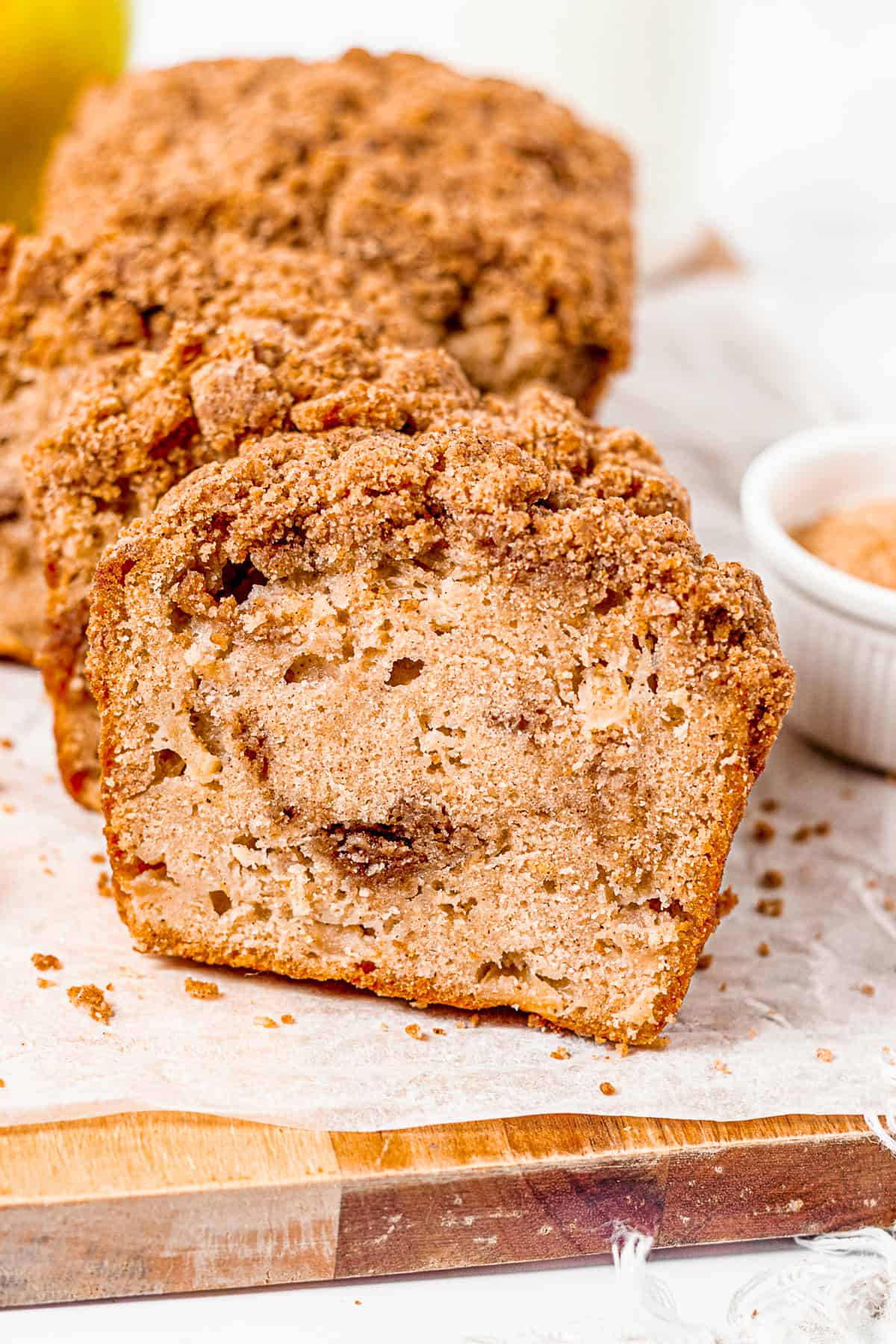 Apple Streusel Bread sliced on a cutting board.