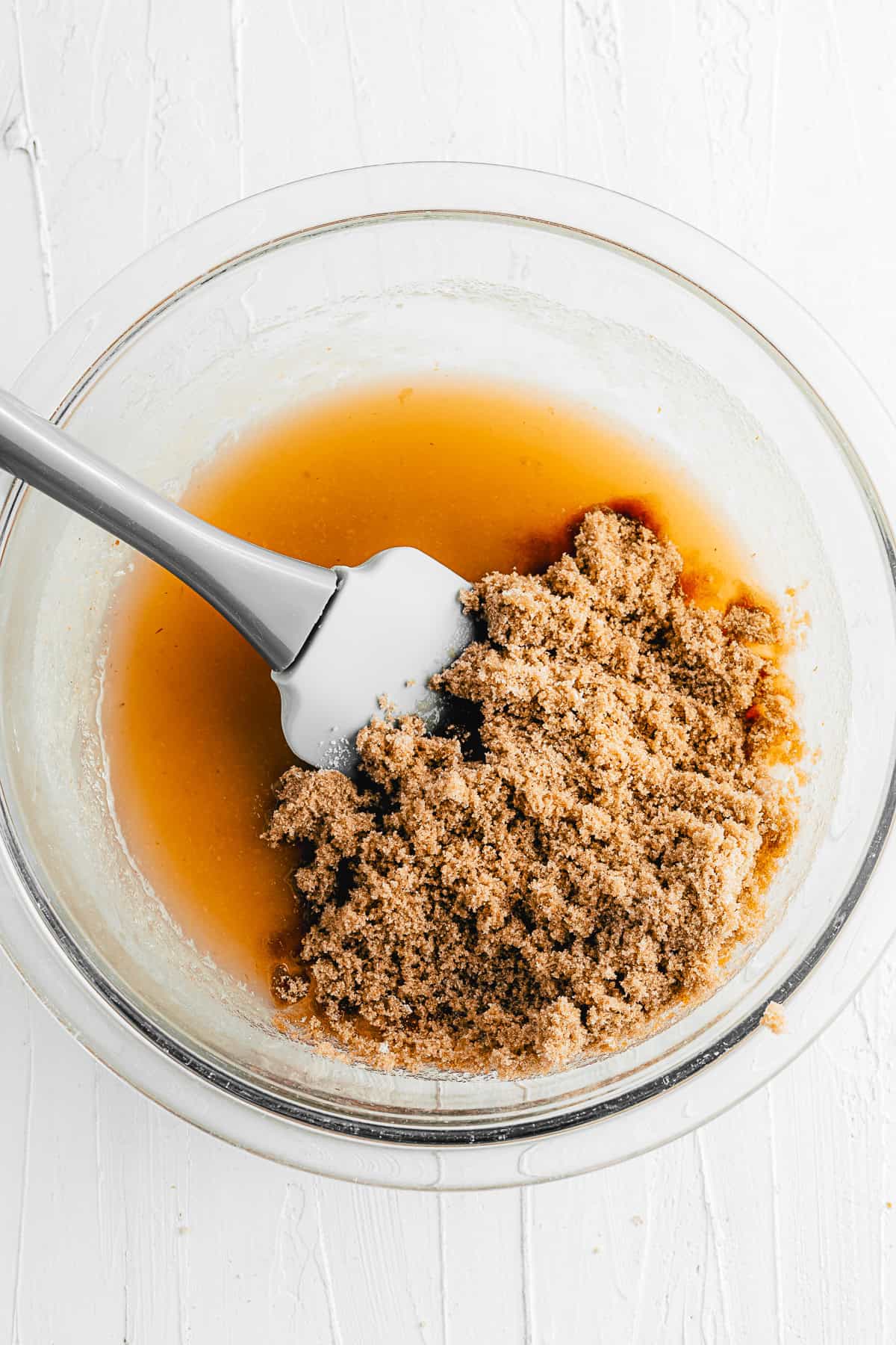 Brown sugar getting mixed with applesauce. 