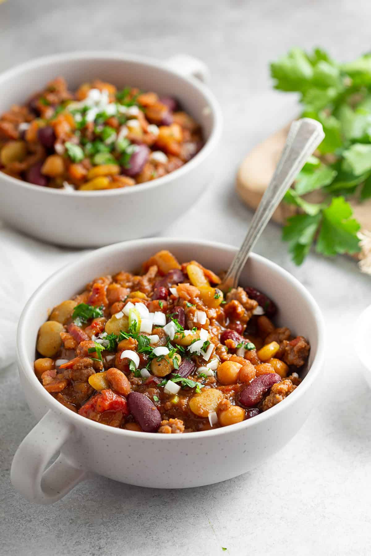 BBQ Calico Beans in a bowl with a spoon. 