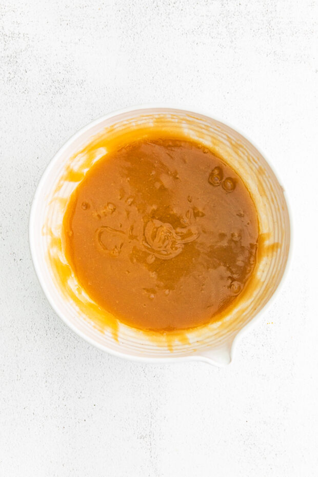 Melted butter and sugar mixed in a bowl. 