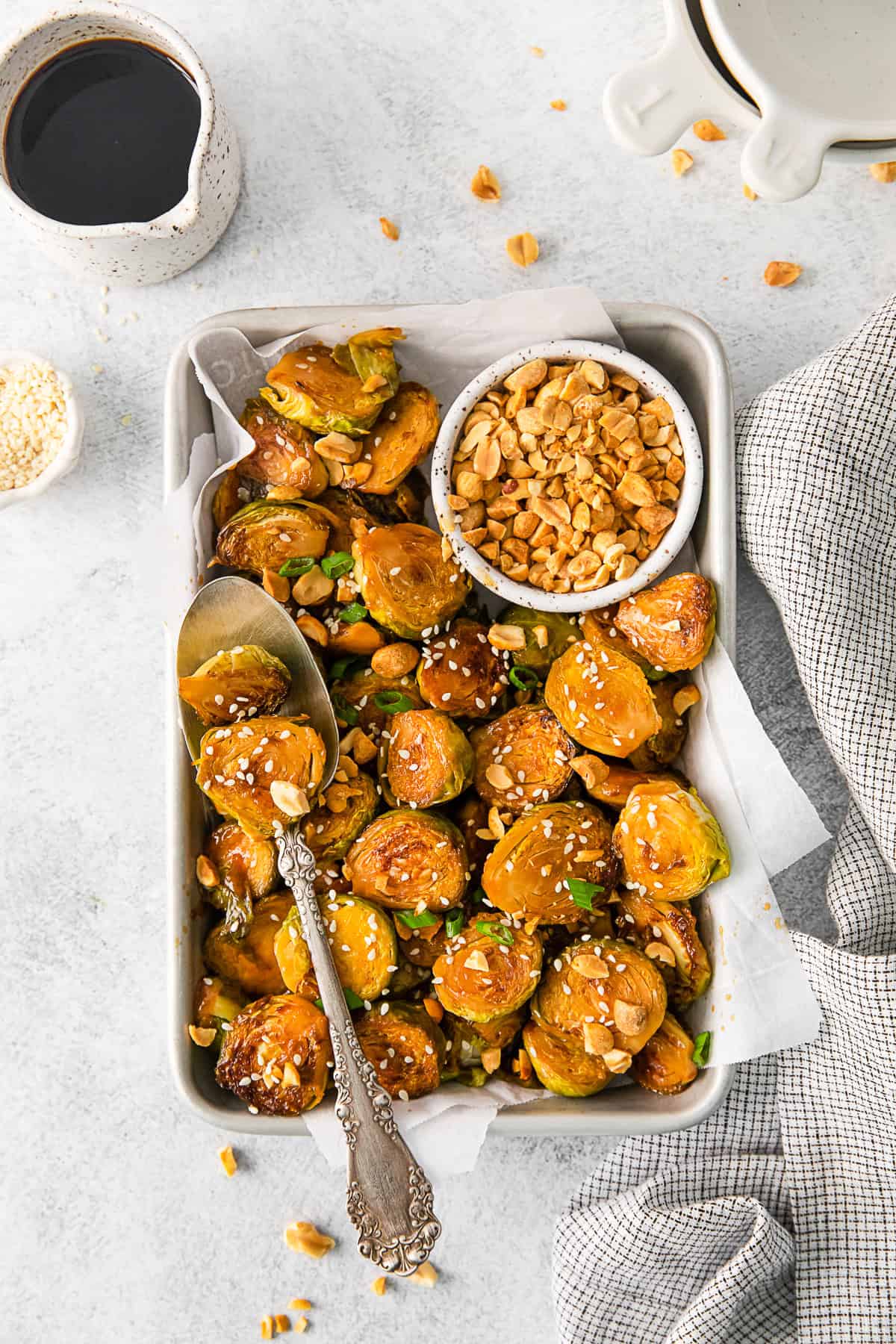Kung Pao Brussels Sprouts with crushed peanuts, sesame seeds, and green onions. 