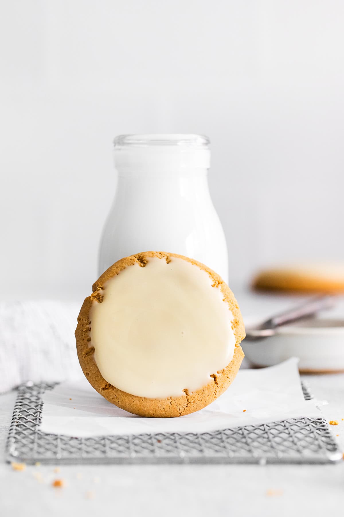 Maple Glazed Cookie sitting on a bottle of milk. 