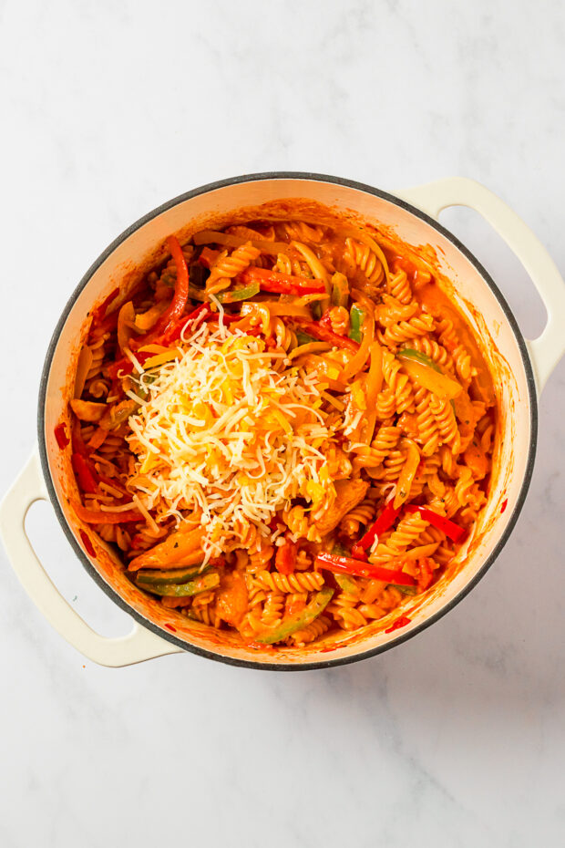 One Pot Chicken Fajita Pasta topped with cheese. 