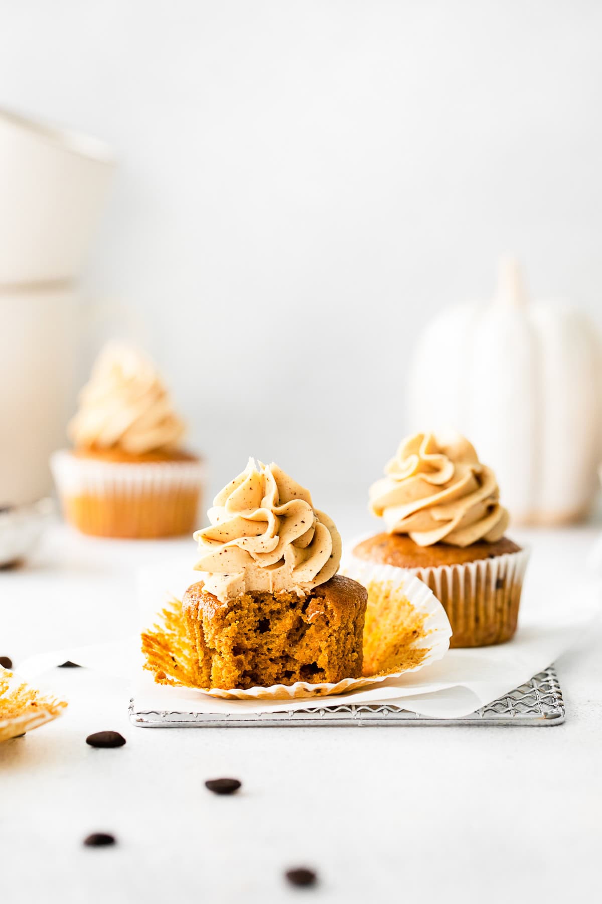 A bite taken out of a Pumpkin Spice Latte Cupcake. 