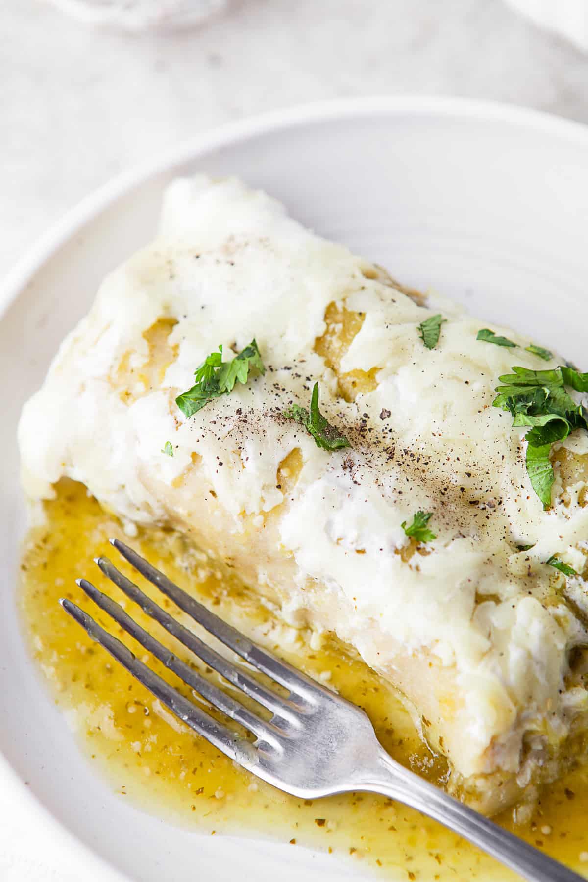 Salsa Verde Chicken Enchiladas on a plate with cilantro. 