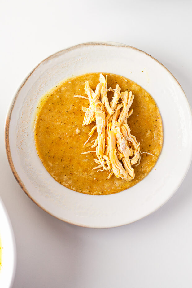 Shredded chicken in a corn tortilla. 