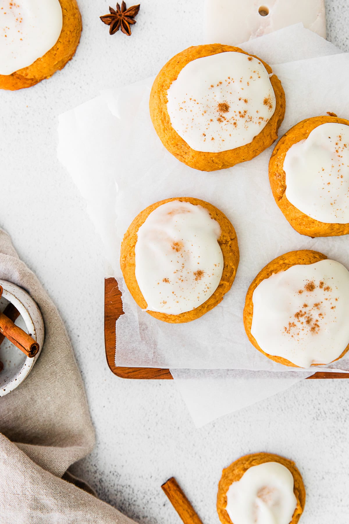 Soft Pumpkin Cookies topped with frosting and cinnamon. 