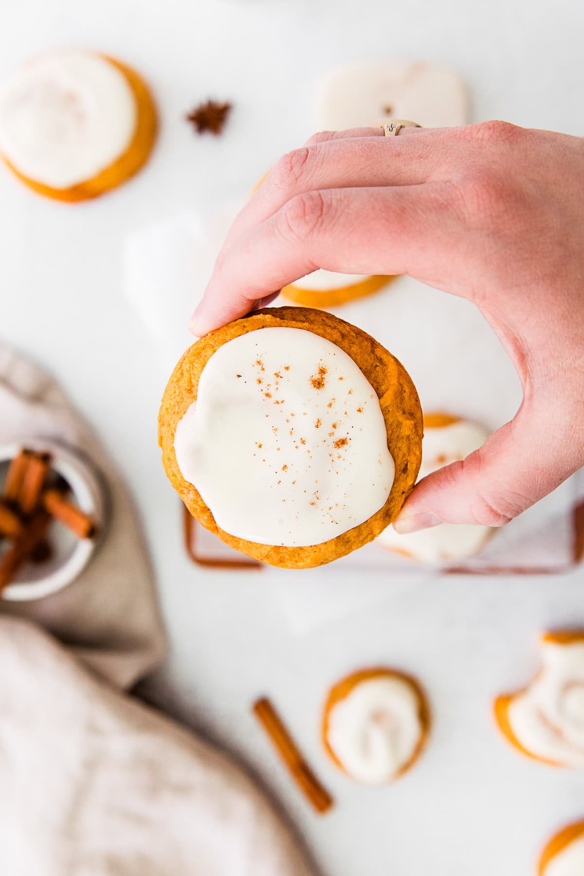 A hand holding a Soft Pumpkin Cookie. 