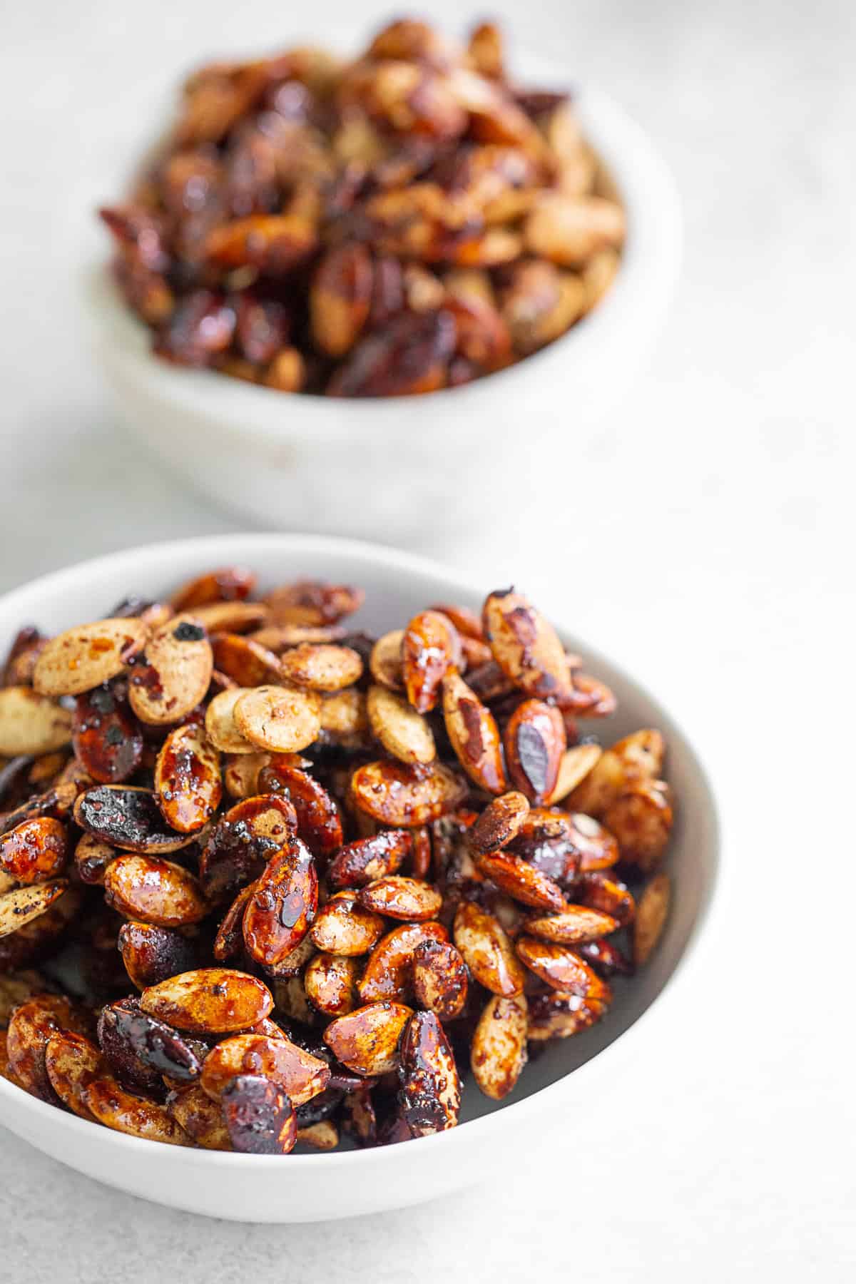 Sweet Salty Roasted Pumpkin Seeds in 2 small bowls.